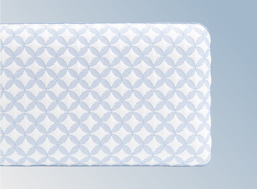 An image of the GlacioTex Cooling Pillow on a light blue gradient background
