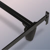 Close-up of a black metal bed frame on a gray background