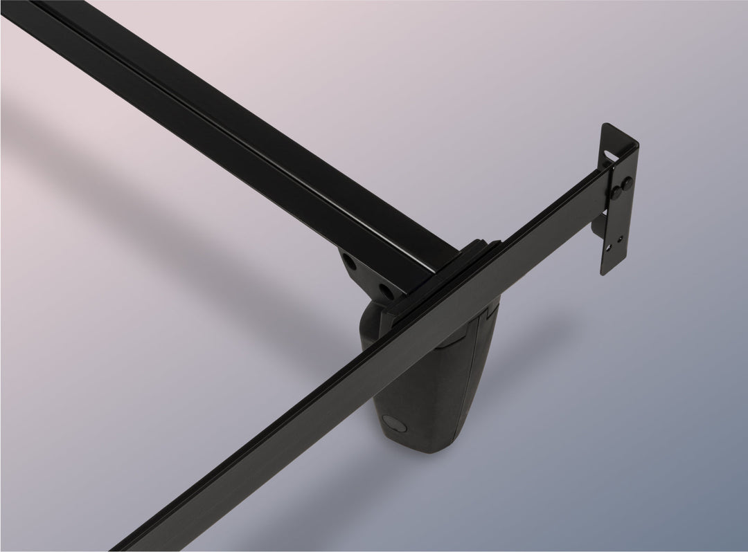 Close-up of a black metal bed frame on a gray background