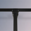 Close-up of a black metal bed frame on a gray background