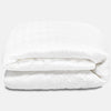 An image of the GlacioTex Mattress Protector folded up on a white background