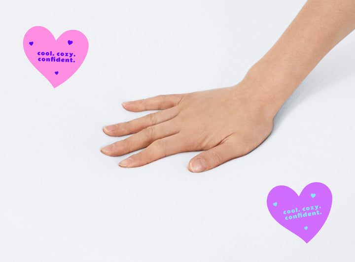 A closeup of the Kids Waterproof Mattress Encasement with a hand feeling the surface