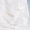 A closeup of the Tencel Sheet Set on a blue background