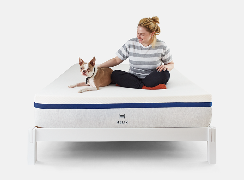 Woman and dog sitting on Helix mattress on Helix white wood bed frame